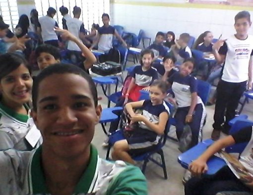 Selfie tirada em uma sala de aula por um aluno com diversos outros ao fundo